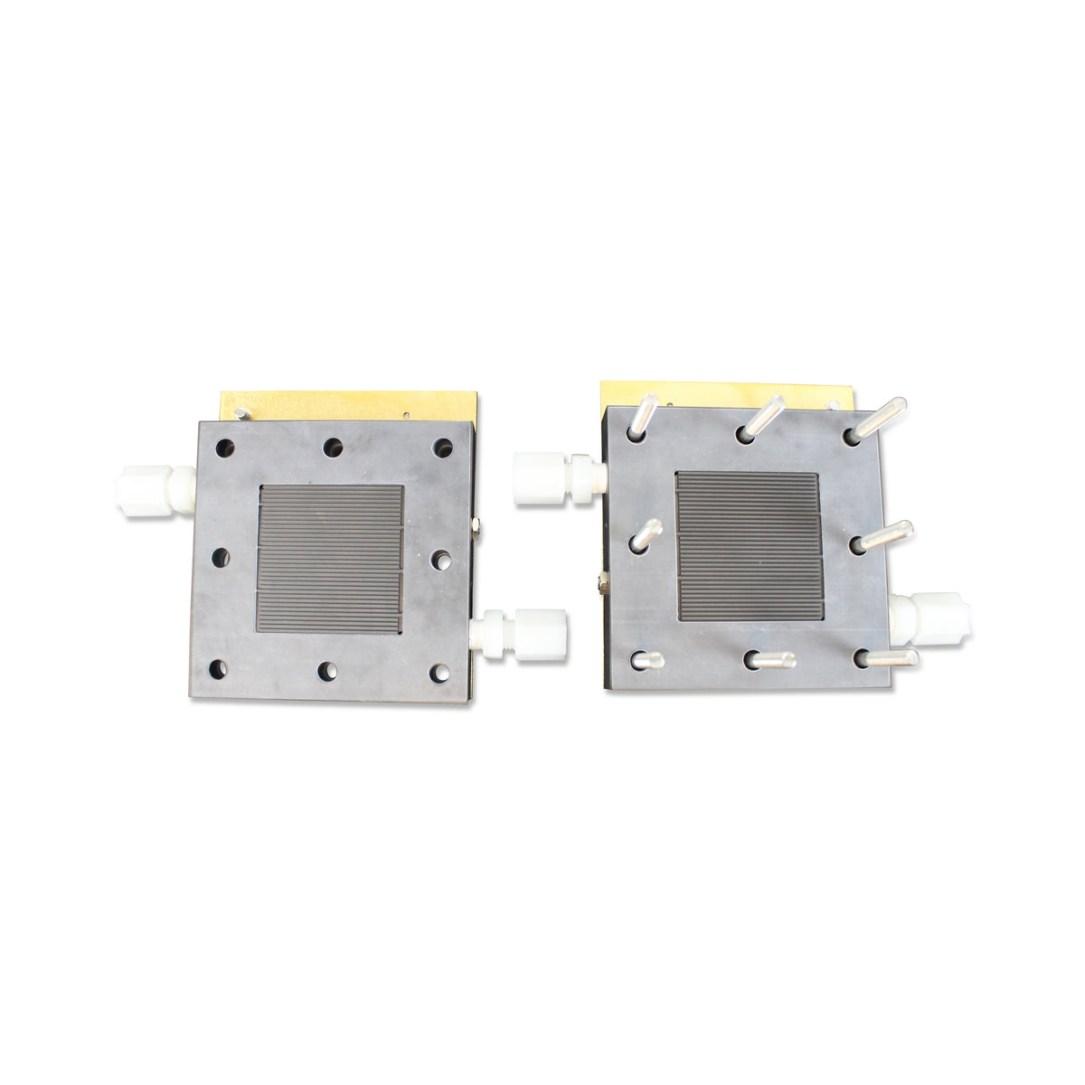 Single-cell test fixture opened to show both flow field plates with parallel-channel active areas